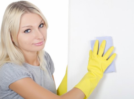 Domestic cleaner tidying a kitchen in Harrow